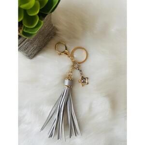 Coach golden silver flower with gray tassel keychain